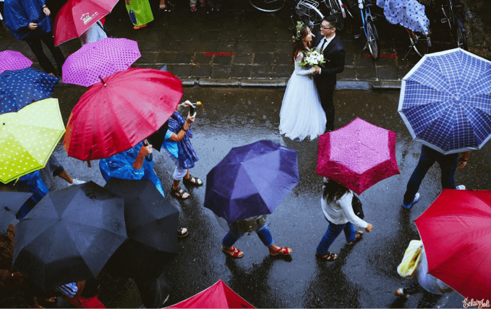 Bride and groom are surrounded by colorful umbrellas. (Picture of Elair Joli) - Instagram