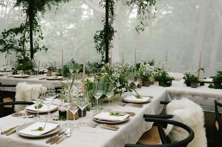 Lots of greenery covers the dining tables while white flowers decorate aside tons of candles. - Instagram
